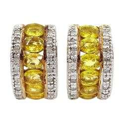 Pair of 10ct gold oval yellow sapphire half hoop earrings, earrings, either side set with diamond chips, stamped