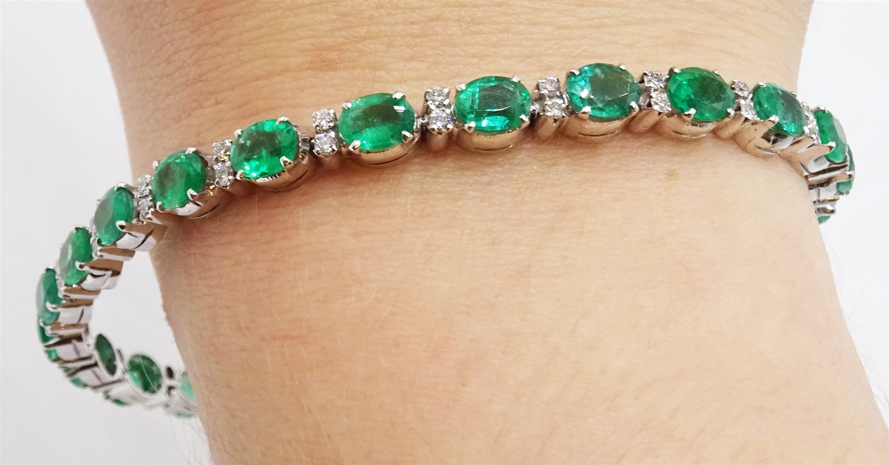 18ct white gold oval emerald and diamond bracelet, stamped 750, emerald