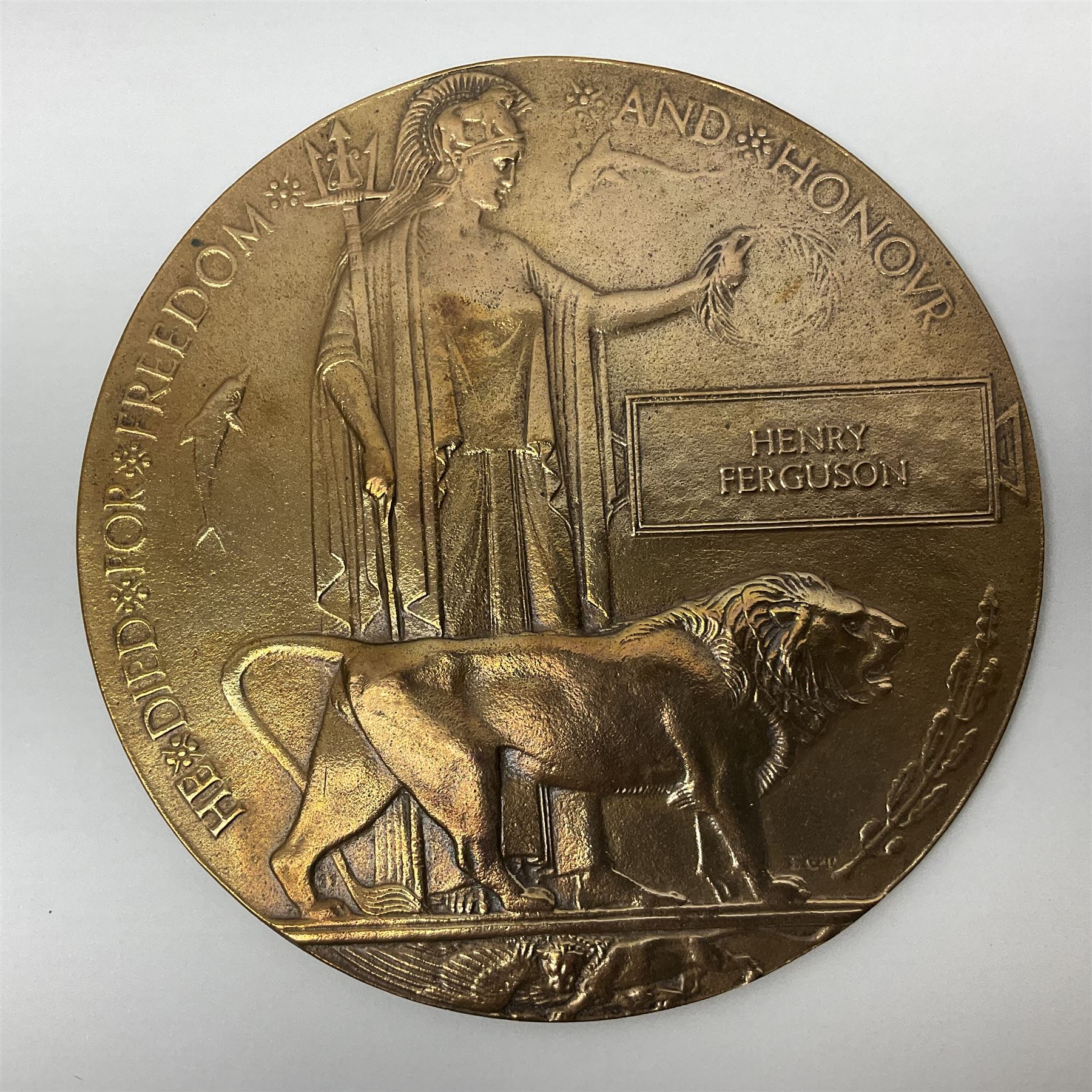 WWI pair of medals comprising British War Medal and Victory Medal awarded to G/62196 Pte. H. Ferguson R. Fus. with ribbons on wearing bar; together with bronze memorial plaque to Henry Ferguson (3)