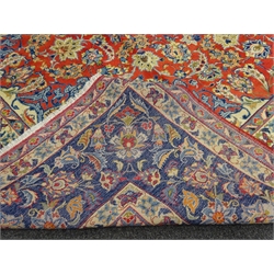  Persian Kashan rug carpet, central medallion surround by interlacing foliage and stylised flower heads on red field, shaped ivory spandrels, five band border, wide middle band with repeating floral decoration, 421cm x 303cm  