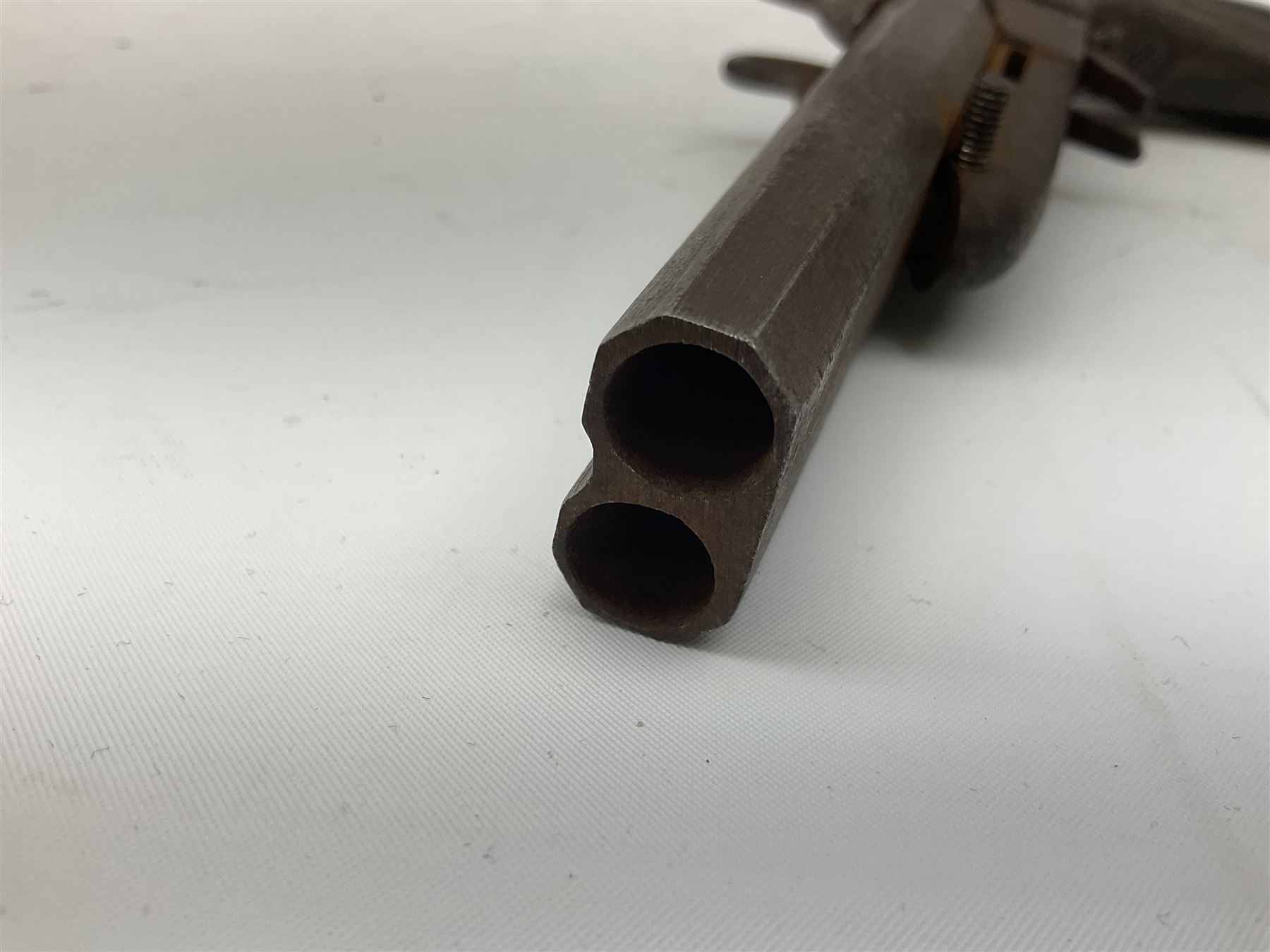 19th century Belgian 9mm side-by-side double barrel pin-fire pocket pistol with 11cm octagonal single block barrel, drop-down triggers and carved walnut stock L22.5cm overall