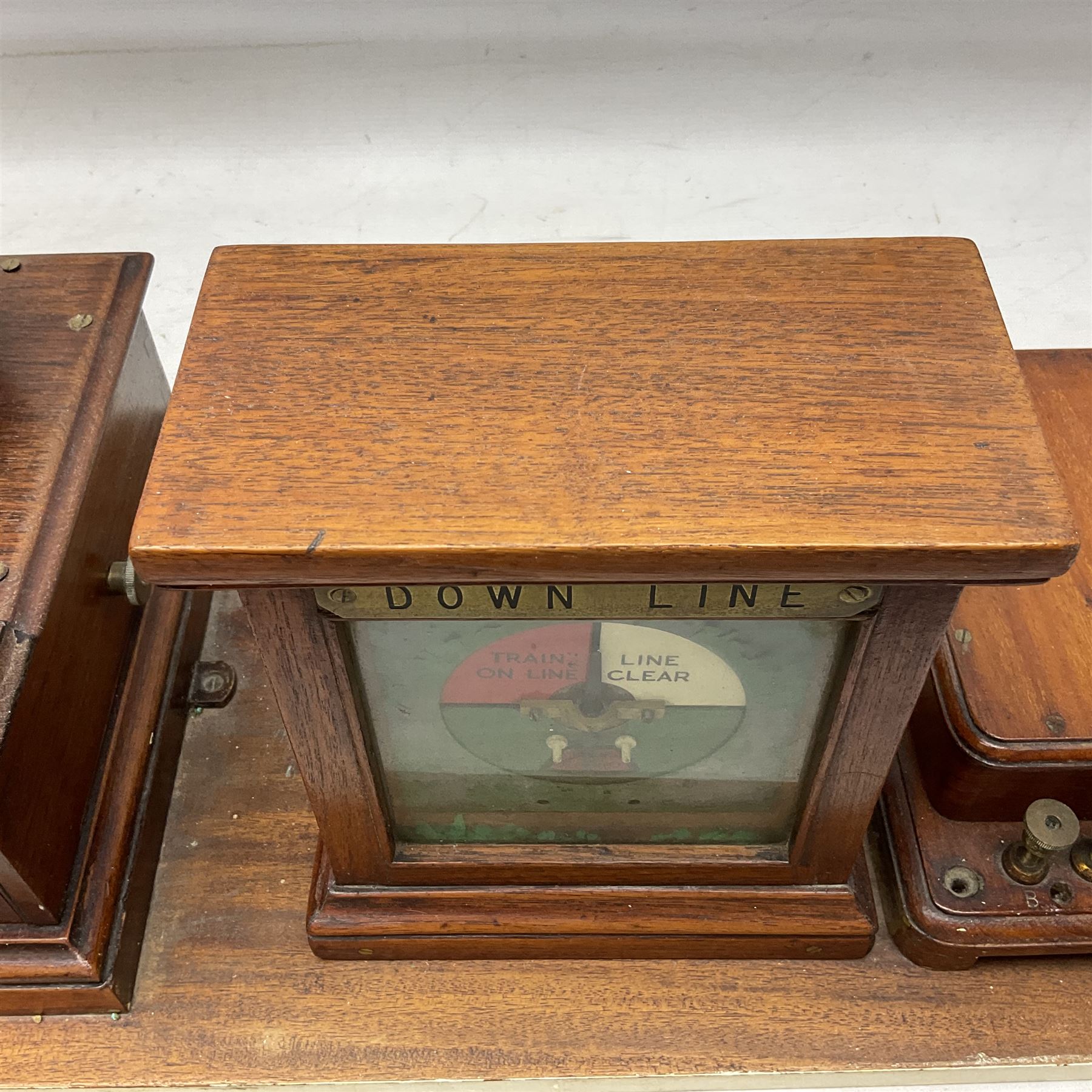 Railway signal boxes, mounted on plinth, with railway block indicators for Up Line and Down Line, having an electromagnetic indicator showing 'Train on Line' 'Line Clear' and 'Line Blocked', and brass signal bell to the centre, L100cm