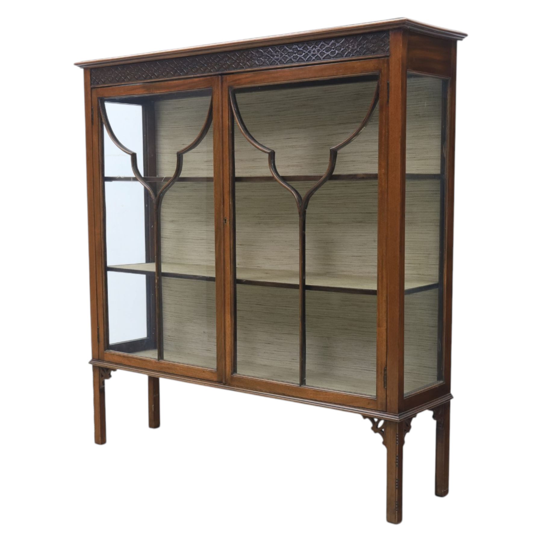 Edwardian mahogany display cabinet, blind-fretwork frieze over astragal glazed doors, square legs with fretwork detail