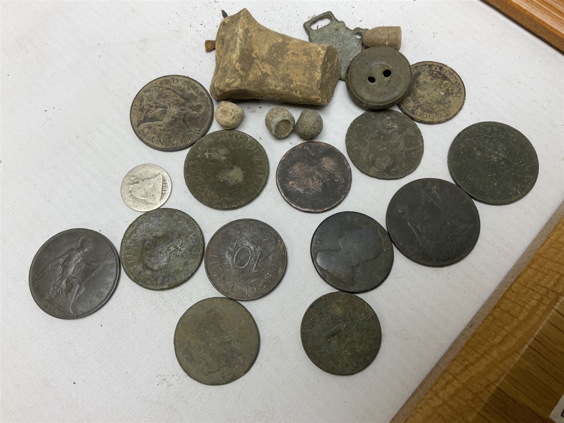 Collection of metal detecting finds and antiquities, housed on five display boards and some loose, to include coins, keys, axe head etc 