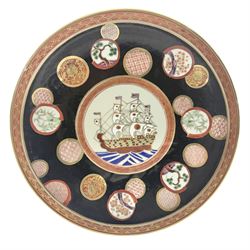 Chinese export charger, the centre decorated in enamel with a ship at full sail, surrounded by enamel panels of bamboo and cherry blossom with gilt edging on a black ground, with red and gilt border, with painted character marks beneath D34.4cm