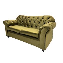 Chesterfield shaped two seat sofa, upholstered in buttoned olive fabric, with scatter cushions