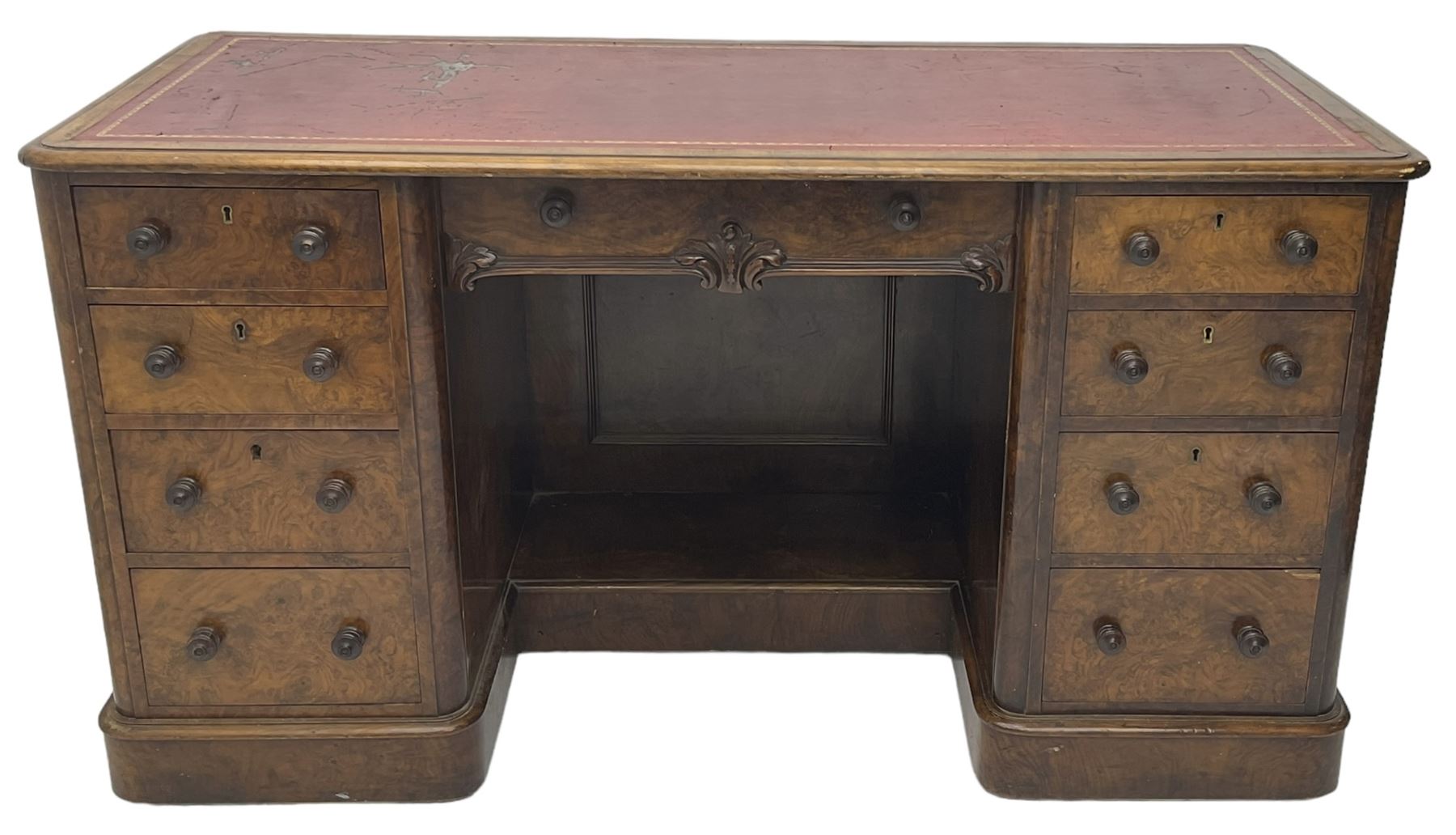 Victorian figured walnut kneehole desk, moulded rectangular top with inset leather writing surface, fitted with nine drawers, the central frieze drawer with carved curled foliage mount, on moulded plinth base,