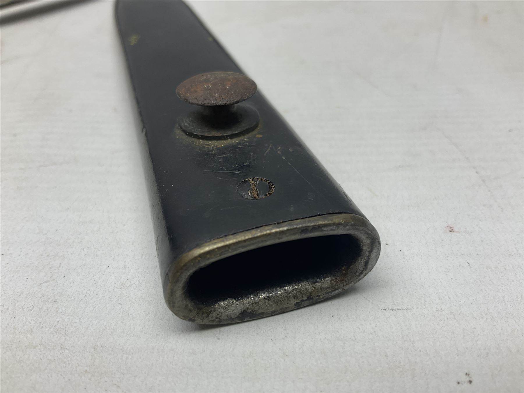 British No 7 MKI knife bayonet with 20cm single edged fullered clipped point blade;  blackened steel, large muzzle ring cross-guard; blackened swivelling pommel marked 'F5H'; red Tufnol composite grips; in blackened steel scabbard L33cm overall; British Pattern 1888 bayonet with scabbard; and German Ersatz bayonet with scabbard (3)