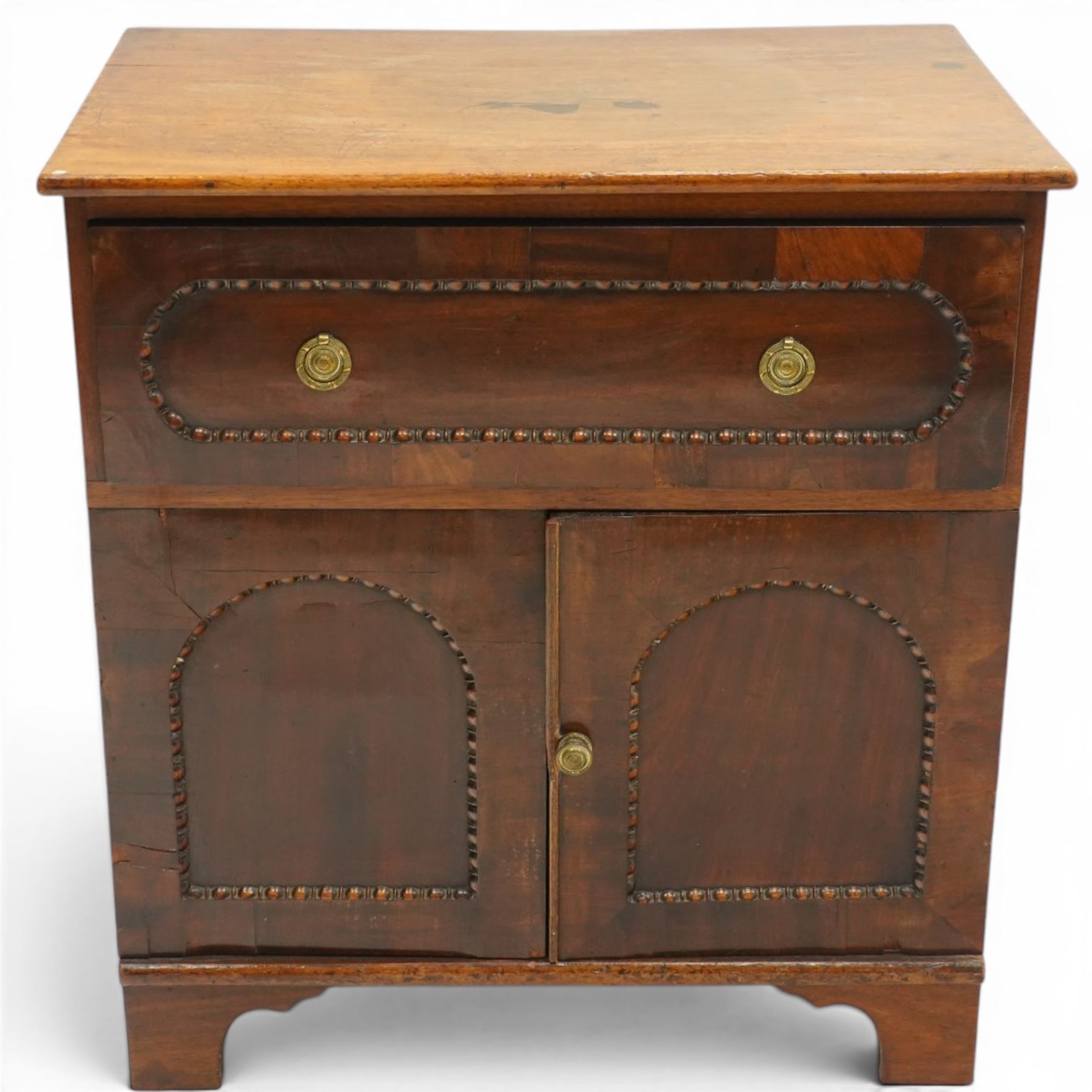 George III mahogany converted commode cabinet, rectangular top over single drawer with egg-and-dart moulding, over two arched panelled cupboard doors, on bracket feet