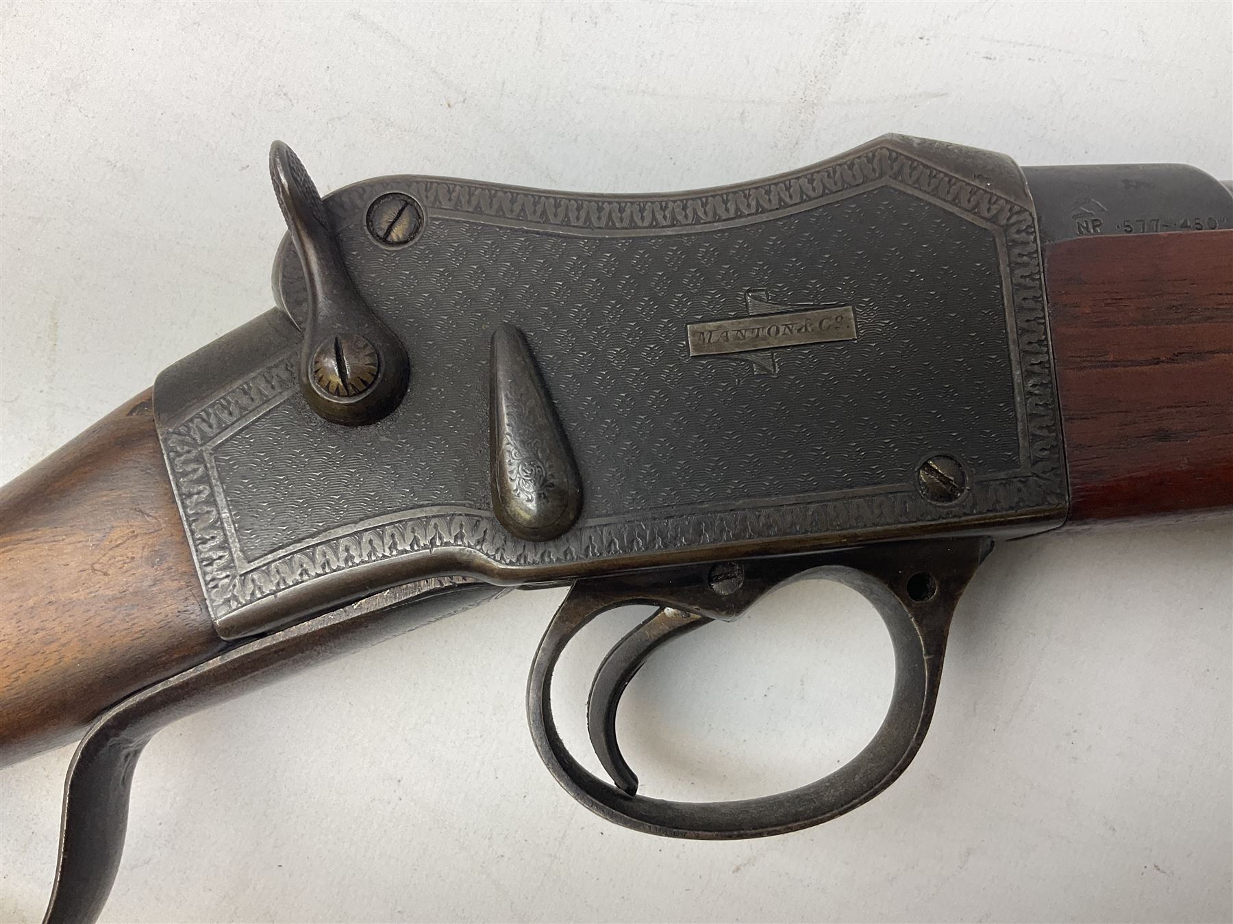 Manton .577/450 Martini Henry rifle, the 82.5cm smooth bored barrel proofed for shot, two barrel bands and bayonet fitting, engraved action with side safety, figured walnut stock with chequered steel butt plate, complete with ramrod, NVN other than 5346 on barrel, L125cm
