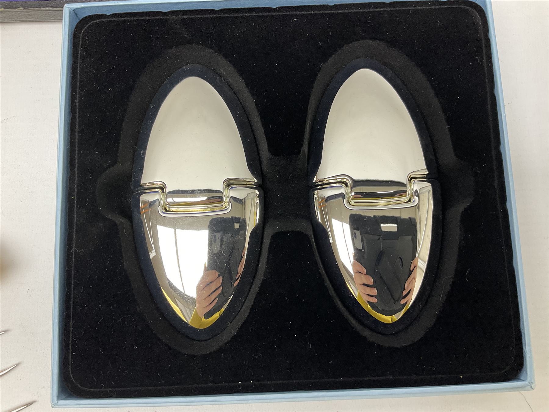 Cased pair of Wedgwood silver-plate book stands, silver-plate baby feeding spoon and pusher in box, other silver-plated cutlery