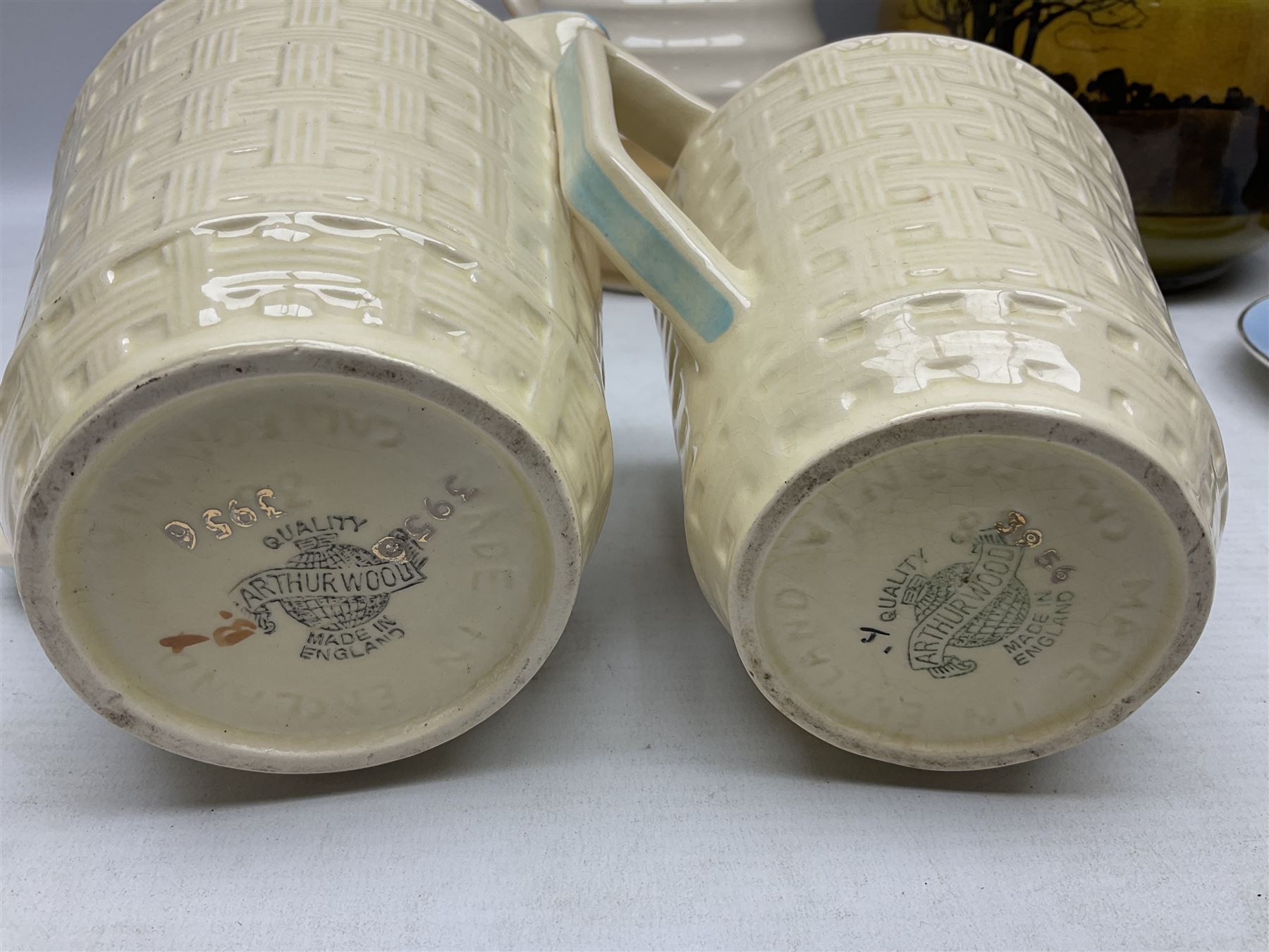 Royal Doulton wide rimmed jardinière, together with two Royal Doulton jugs, Arthur Wood jugs etc