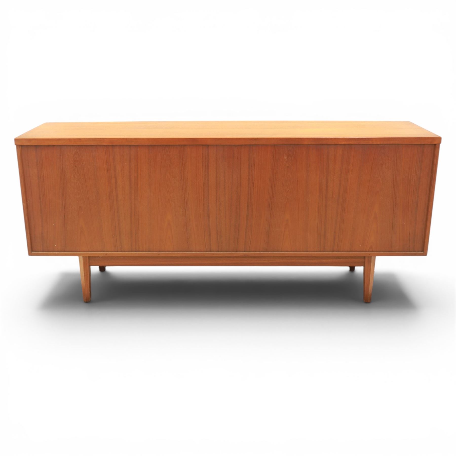 Mid-20th century teak sideboard, rectangular top above four frieze drawers with recessed handles, flanked by two cupboard doors with fall front central media cupboard
