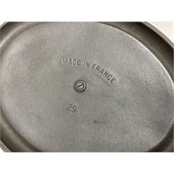 Emile Henry covered casserole dish of oval form in two tone brown and cream, no. 03.06, together with cast iron Nomar twin handled lidded casserole dish of oval form in navy, and other ovenware including Flintware ICTC, largest L35cm