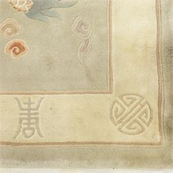 Chinese wool rug, the pale grey central field decorated with two stylised dragons, flaming pearls and cloud scrolls, within a cream border of shou medallions and geometric motifs, with cotton fringe ends
