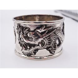 Group of silver, comprising small modern specimen vase with filled base, hallmarked A T Cannon Ltd, Birmingham 1978, Chinese export napkin ring decorated in relief with two three clawed dragons, with character mark, also stamped HM 90, pair of 1930's cruets, the open salt with blue glass liner, hallmarked William Neale & Son Ltd, Birmingham 1932, two George III Old English pattern tea spoons, a George IV Fiddle pattern tea spoon, Dutch 830 standard spoon, the terminal detailed with crowned ship above initials K.N.S.M for the Royal Dutch Steamboat Company, stamped Holland 830 D*D, pair of 1920's coffee spoons with devil terminals, and six cruet spoons, including a pair, all stamped 925, approximate total weighable silver 6.01 ozt (187 grams)