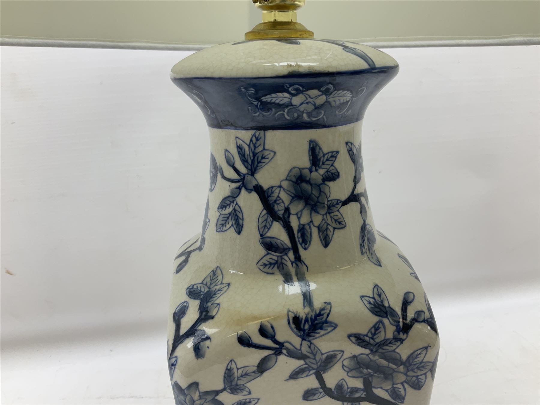 India Jane table lamp, decorated with blue birds and floral vines upon a white ground, fitted with a cream lampshade, H62cm 