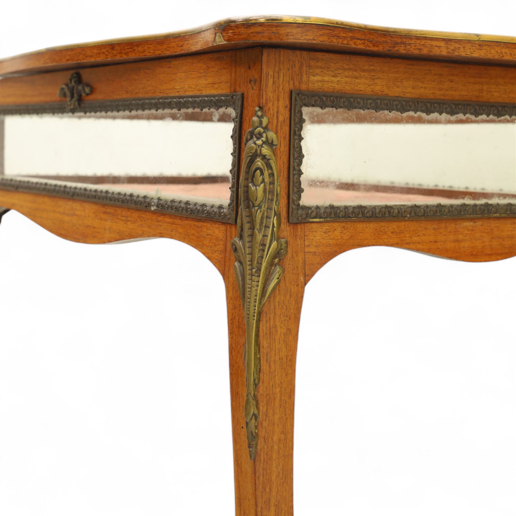 Louis XV revival style walnut bijouterie table, rectangular serpentine form, with brass edging and a hinged floral marquetry inlaid lid with bevelled glass top and sides, gilt-bronze beaded border, interior lined with rich red velvet, raised on slender cabriole legs with gilt bronze masks and sabots, circa 1900
