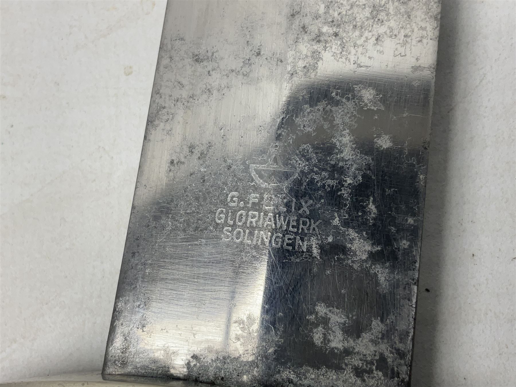 WW2 German SA dagger the 22cm double edged steel blade by G. Felix Gloriawerk Solingen inscribed 'Alles Fur Deutschland', the cross-piece impressed with the SA Gruppen mark Nm verso for Nordmark, wooden grip inset with eagle and SA emblem; in brown painted scabbard with nickel mounts L37cm overall