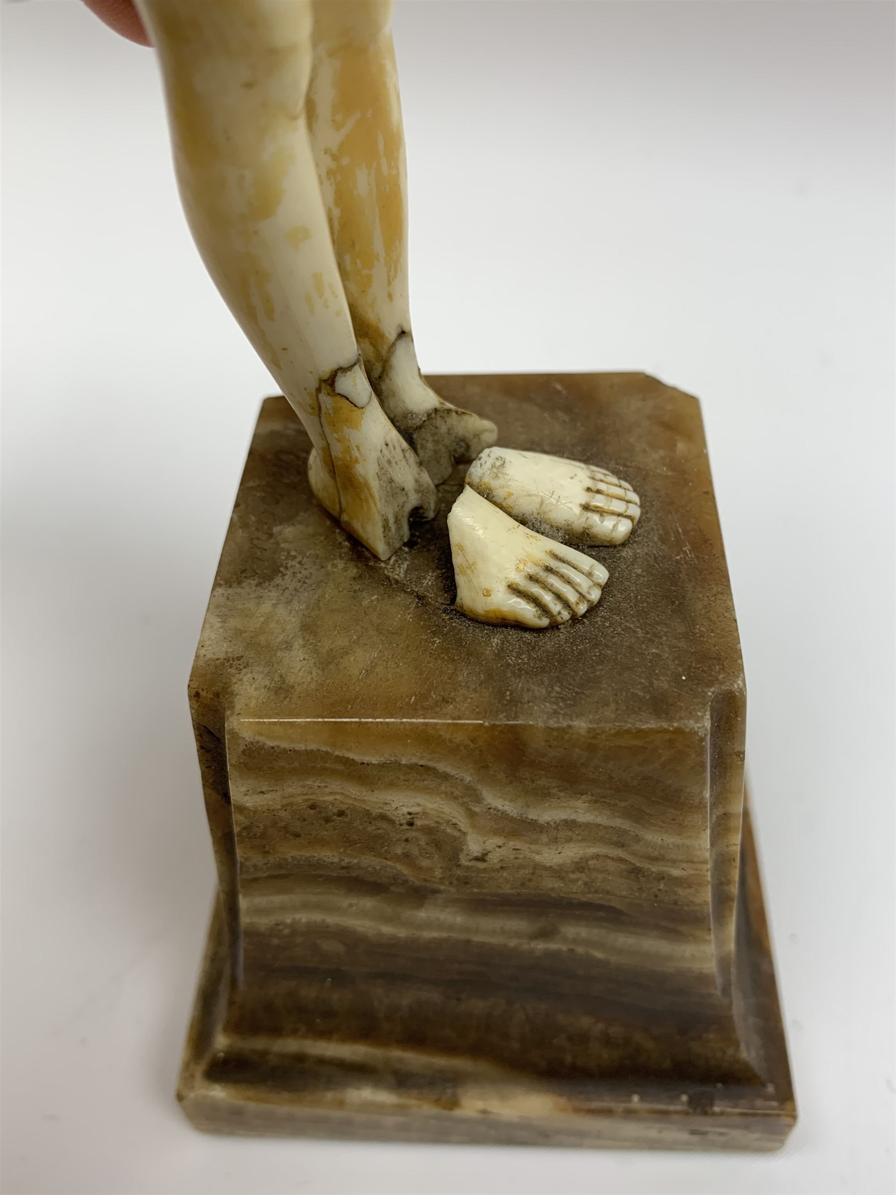 Demetre Chiparus (1886-1947): Innocence, a gilt bronze and ivory figure, circa 1925, standing in contemplative post with hands clasped, upon onyx plinth, signed to base, H24.4cm