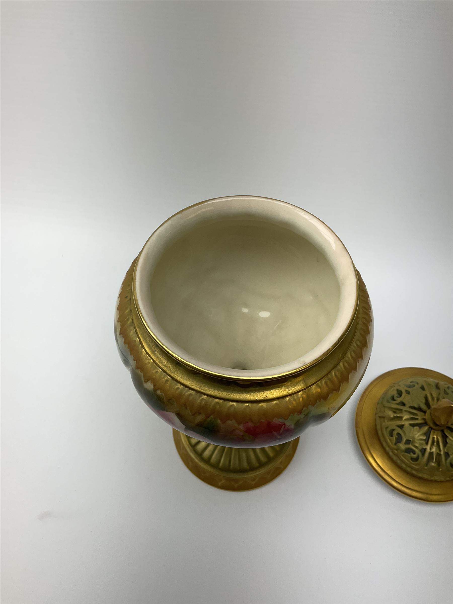 A Royal Worcester potpourri vase and cover, shape 1813, the bulbous body hand painted with pink roses and signed A Watkins, supporting a gilded and burnished pierced cover, upon a moulded stem with zoomorphic mask detail and circular foot, with puce printed mark beneath, H24cm