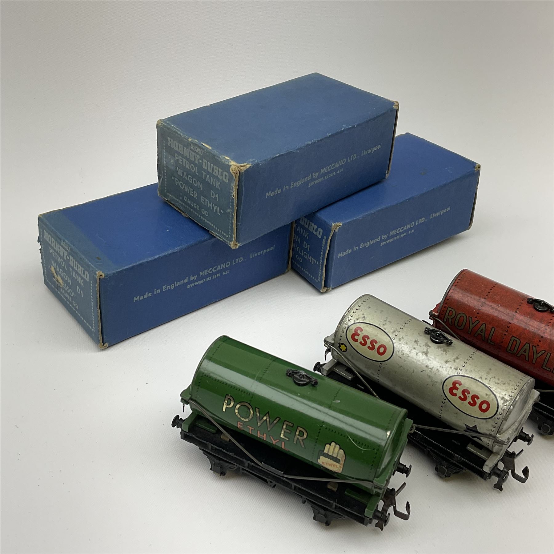 Hornby Dublo - Petrol Tank Wagon D1 'Power Ethyl'; Oil Tank Wagon D1 'Royal Daylight'; and Petrol Tank Wagon D1 'Esso'; all in medium blue boxes (3)