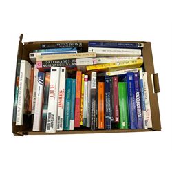 Group of books, mostly self help and psychology related in one box