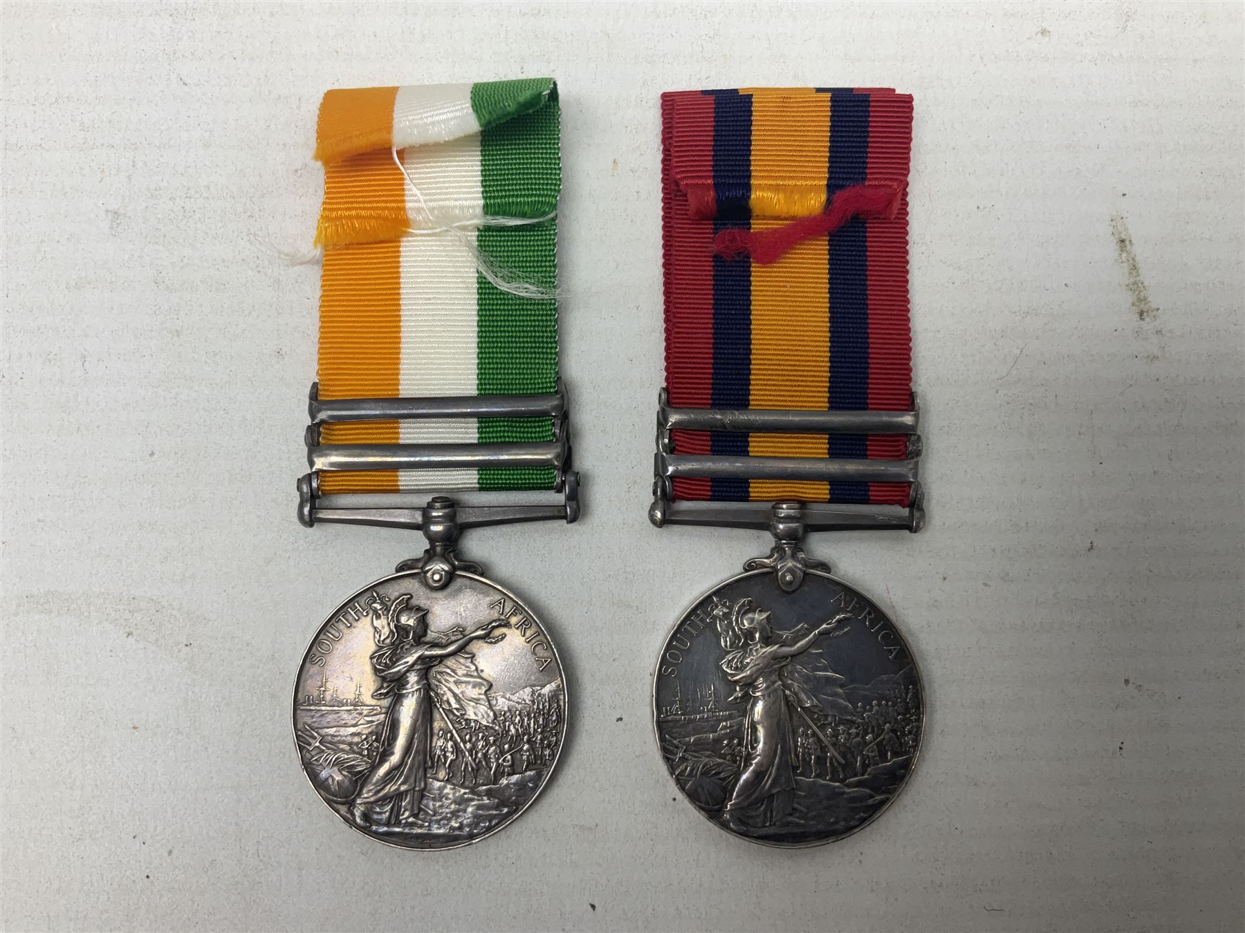 Boer War pair of medals comprising Queens South Africa Medal with two clasps for Paardeberg and Relief of Kimberley and Kings South Africa Medal with two clasps for South Africa 1901 & 1902, awarded to 9752 Dvr. T. Finan A.S.C. with ribbons (2)