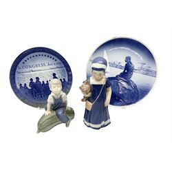 Two Royal Copenhagen figures, Else with teddy, no 671, and boy seated on a marrow no 4539 together with two Royal Copenhagen plates 