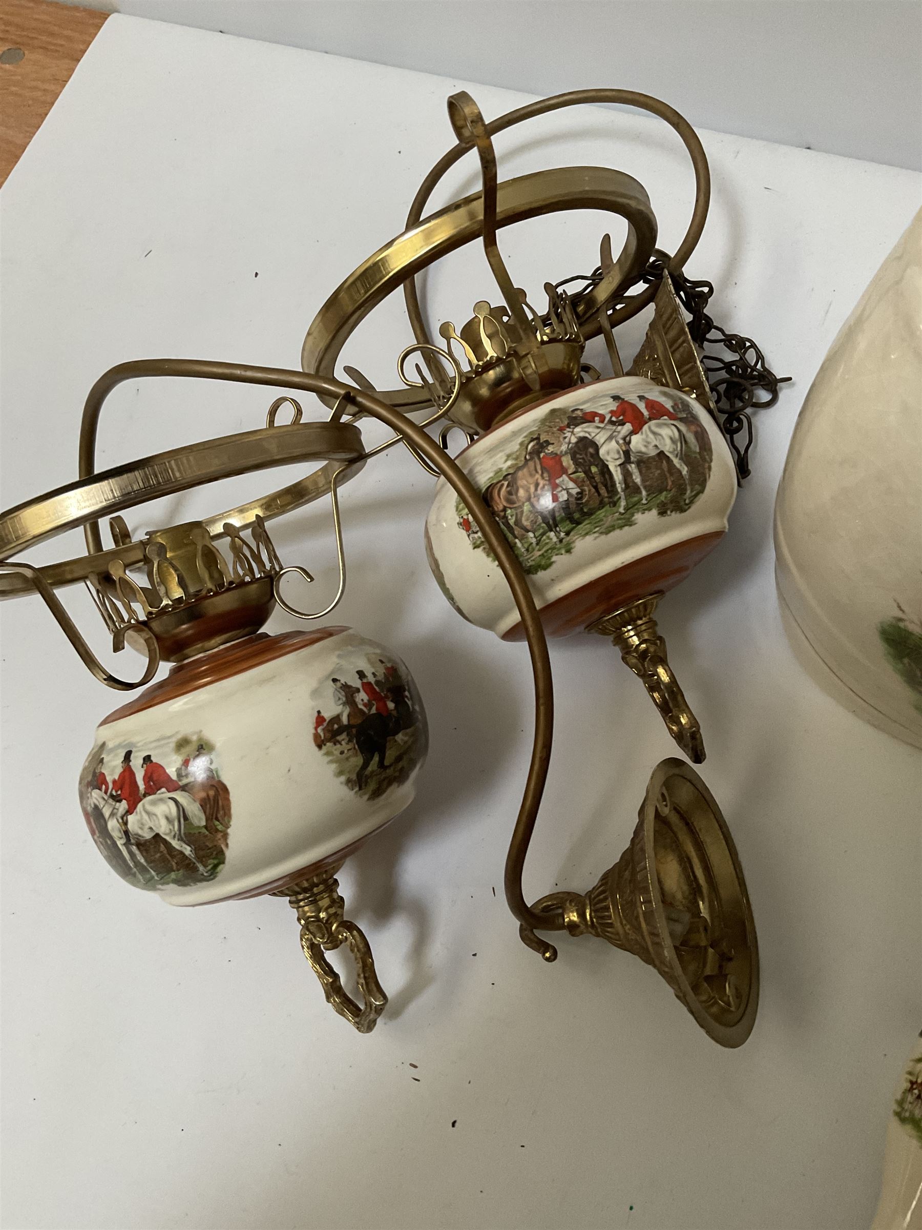 Ceramic hanging light fittings decorated with fox hunting scenes with brass fixtures, ceramic beer pulls decorated with hunting scenes and ceramic whisky barrel decorated with a pheasant