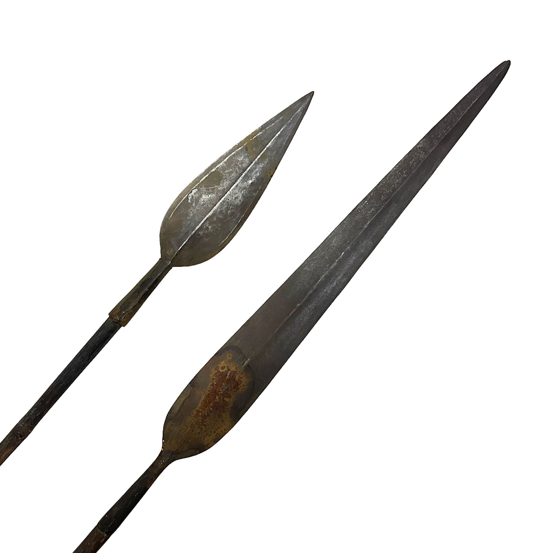 Native long-shafted spear, the large iron head with central medial ridge and decorative neck, on plain circular haft L260cm; and another similar Native long-shafted spear with cane haft L249cm (2)