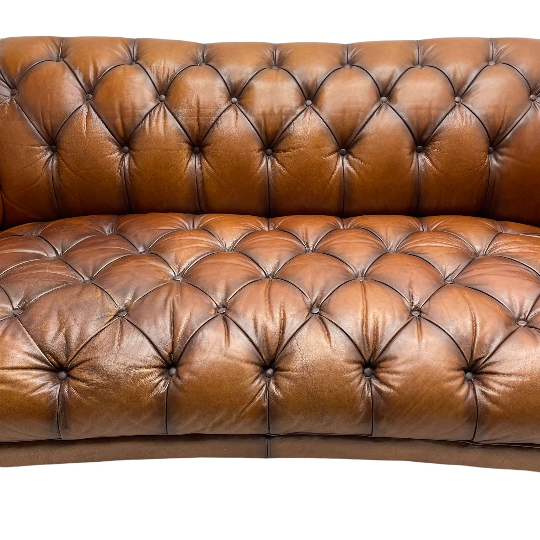 Tetrad - 'Oskar' grande three-seat sofa, Chesterfield shape with rolled arms, upholstered in buttoned tan leather, on turned and reed moulded feet 