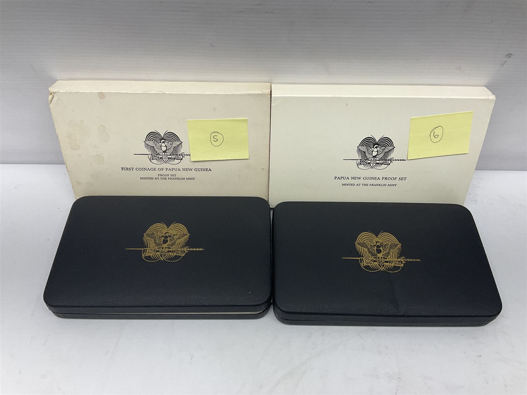 Four Papua New Guinea proof eight coin sets, from ten kina to one toea, comprising First Coinage of Papua New Guinea 1975 proof set, 1976, 1977, and 1979 proof sets, the 1977 and 1979 sets containing 925 silver ten kina and 500 silver five kina coins, all minted at the Franklin Mint, cased with certificates (4)