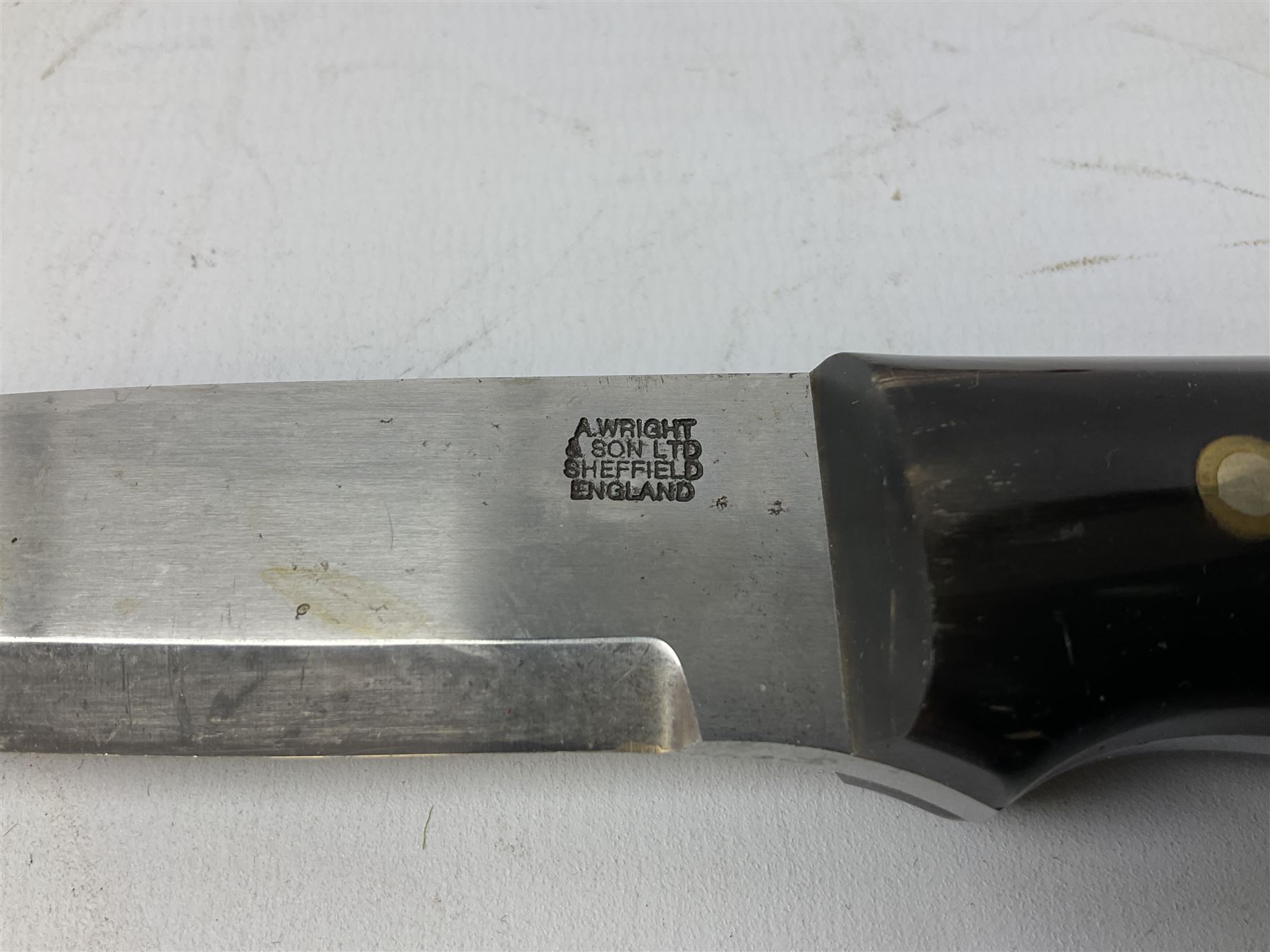 Three hunting knives, each blade marked A. Wright & Sons Sheffield, one with leather handle, one with horn handle and one with antler handle; each with leather sheath (3)