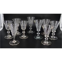 Nine 19th century drinking glasses with wrythen twist and part fluted bowls, comprising a set of three with bell shaped bowls, a near set of three with funnel bowls, a further similar pair, and a single example with drawn trumpet bowl, tallest H11.5cm