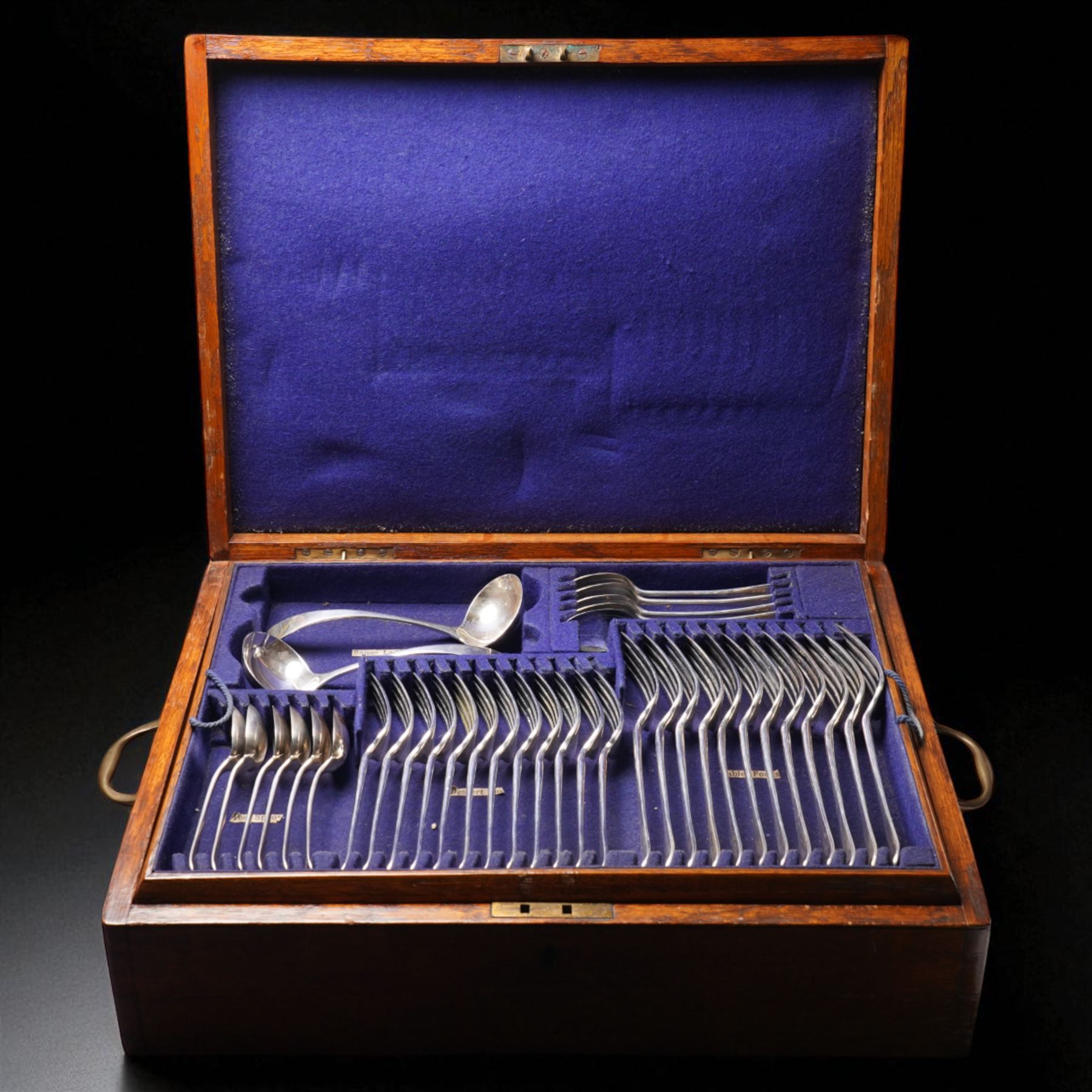 Canteen of Edwardian silver Old English pattern cutlery for twelve covers comprising twelve table forks, twelve dessert forks, twelve soup spoons, twelve dessert spoons, eleven tea spoons, pair of sauce ladles, four table spoons and a basting spoon in oak case London 1907 Maker Charles Boyton & Son