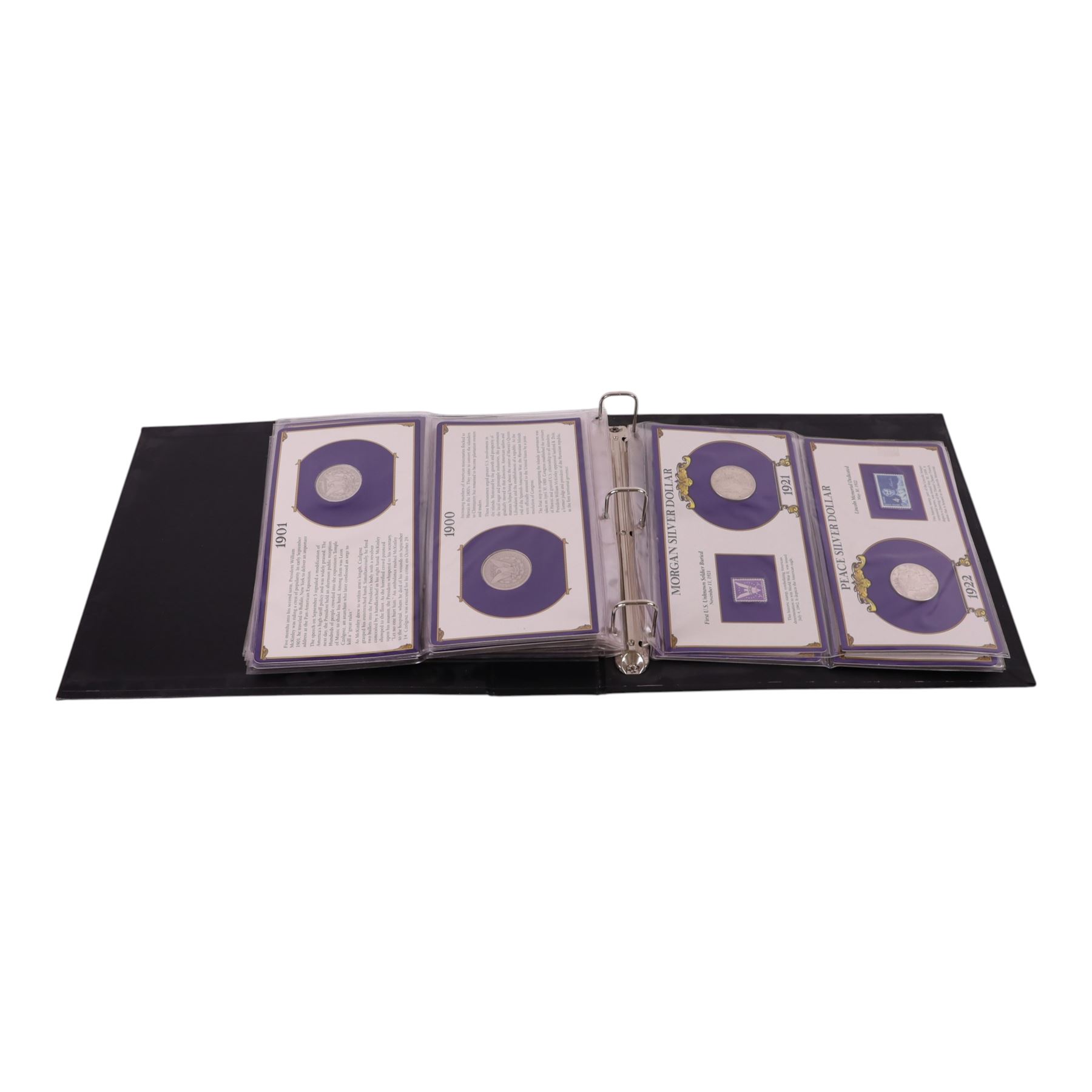 Twenty-five United States of America silver one dollar coins, comprising eighteen 'Morgan' and seven 'Peace' dollars, in 'The U.S. Silver Dollar Collection' ring binder