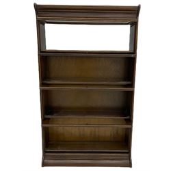 Early 20th century oak stacking library bookcase, four sections enclosed by hinged and sliding glazed doors