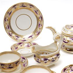 Early 19th century Derby tea and coffee service painted with a border pattern of purple and gilt leaves and flowers comprising four large cups with five saucers, nine coffee cans with twelve saucers, tea pot and stand, slop bowl, milk jug and two plates, red painted mark.
