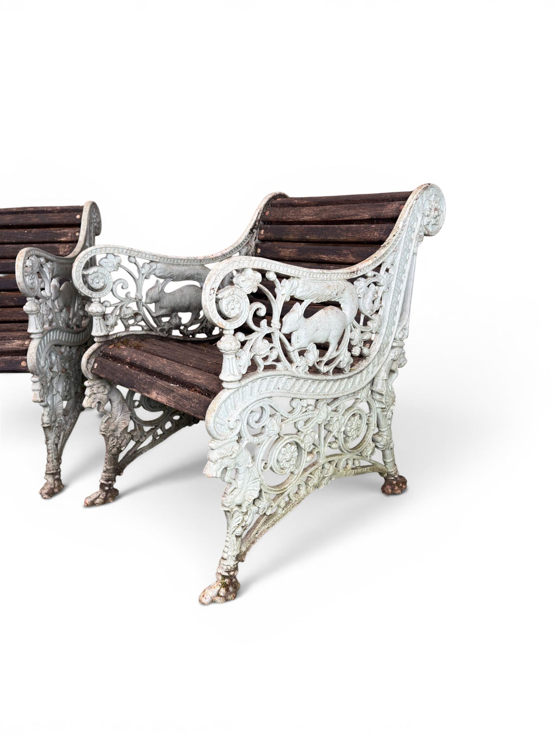 Pair of unusual Victorian revival heavy cast iron garden chair benches, ornate scrollwork detail with squirrels and nature, serpentine wood slatted seat and back - design by George Smith at the Sun Foundry, Glasgow
