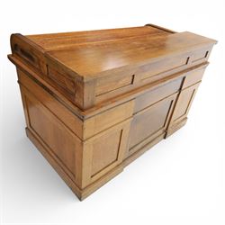 Globe Wernicke - Oak roll top desk, fitted with nine drawers, oak tambour roll top revealing a fitted interior, with single frieze drawer, flanked by four drawers to each pedestal, on a plinth base