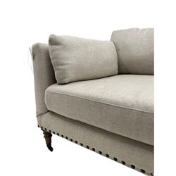 Grande three-seat sofa, traditional shape, upholstered in textured grey fabric, on turned supports with castors