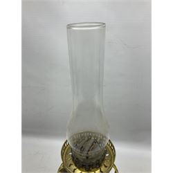 Victorian cast spelter oil lamp, decorated with cherubs and foliate scrolls, supporting a glass reservoir, burner and clear glass chimney, H62cm