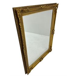 Rectangular gilt framed wall mirror, ornate cartouche decorated frame, plain mirror plate
