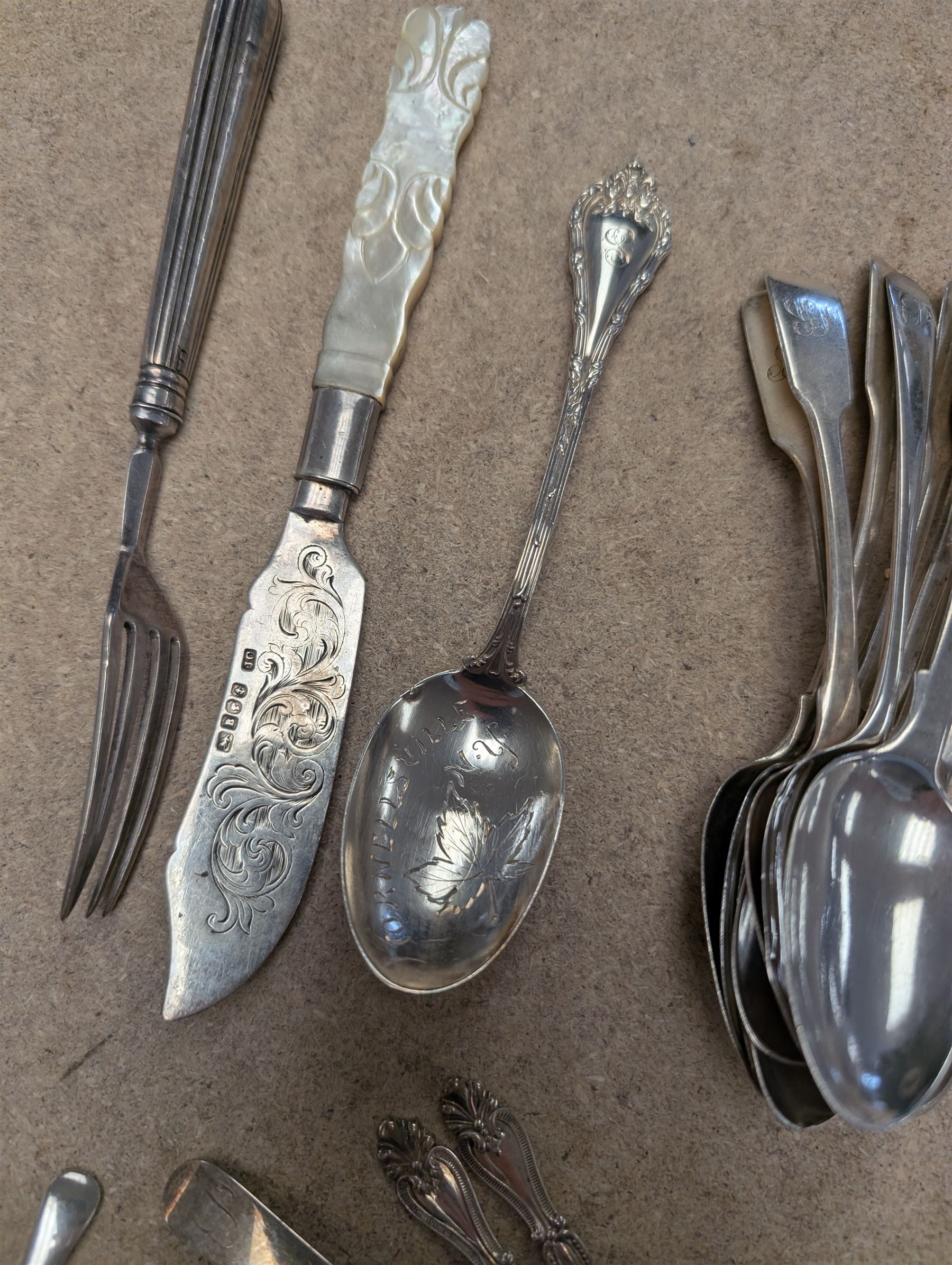 Collection of silver teaspoons, including souvenir and American silver examples, together with a silver handled fork and a mother of pearl handled silver knife, all stamped or hallmarked 