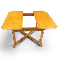 Waring & Gillow - Arts and Crafts oak draw-leaf extending dining table rectangular moulded top with chamfered corners, two additional leaves, carved frieze over fluted section supports, united by low X-shape stretchers