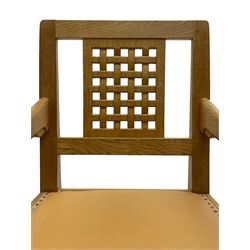 Mouseman - oak carver elbow chair, pierced and carved lattice back over leather upholstered seat with stud band, on octagonal supports united by plain stretchers, carved with mouse signature, by the workshop of Robert Thompson, Kilburn 