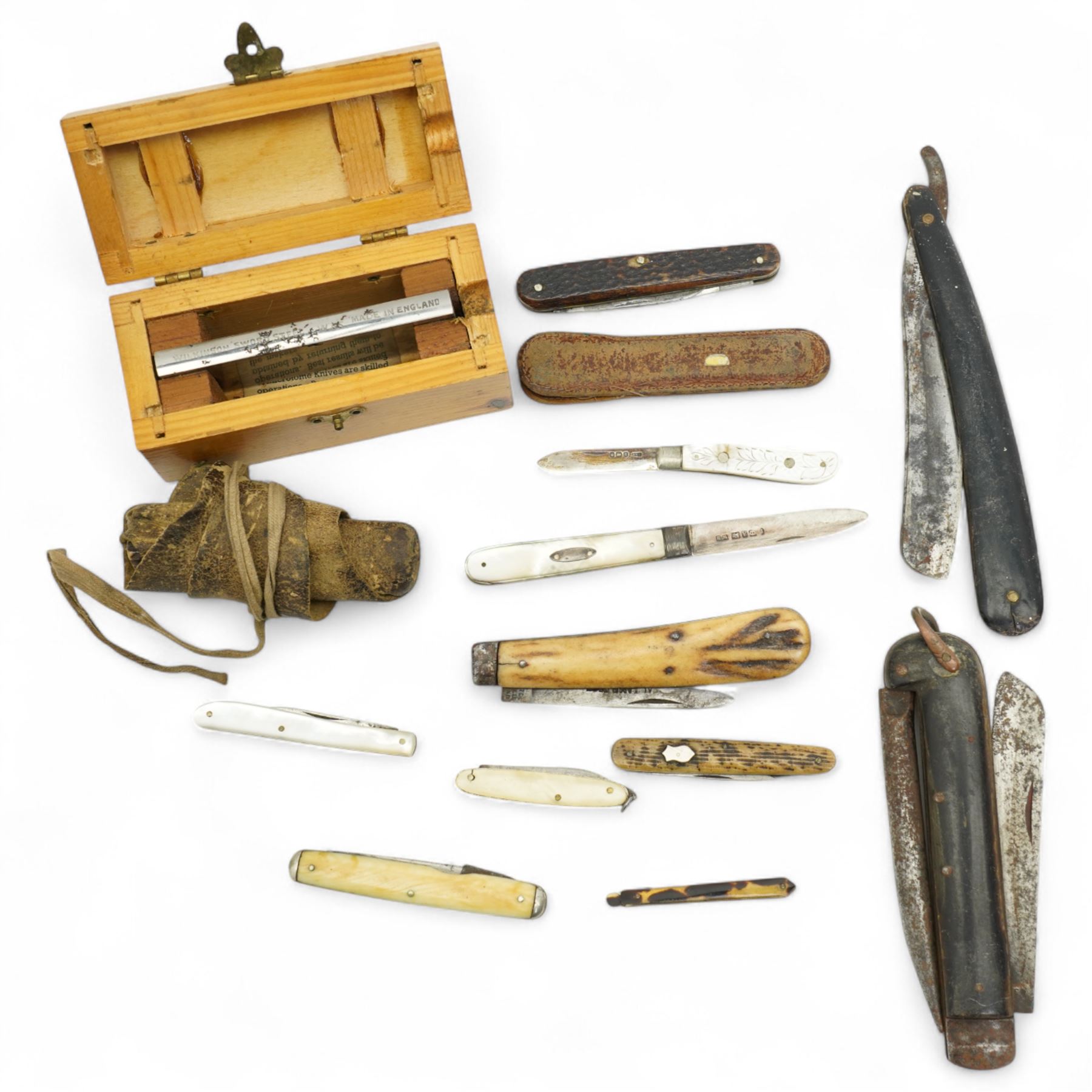 Two mother of pearl fruit knives with silver blades, 19th century pen knife with horn case by William Oates, Sheffield, another by Hunter, Sheffield, various other pen knives, cut throat razor by Barlow, Sheffield and a re-sharpening tool