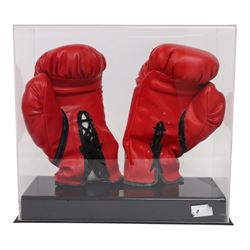 Muhammad Ali and George Foreman signed boxing gloves, two Everlast gloves the left hand glove signed by Ali and right signed by Foreman, both in black marker pen, in Perspex display case with plaque to base displayed with a further unsigned glove, each with Mounted Memories holographic stickers, case H36cm