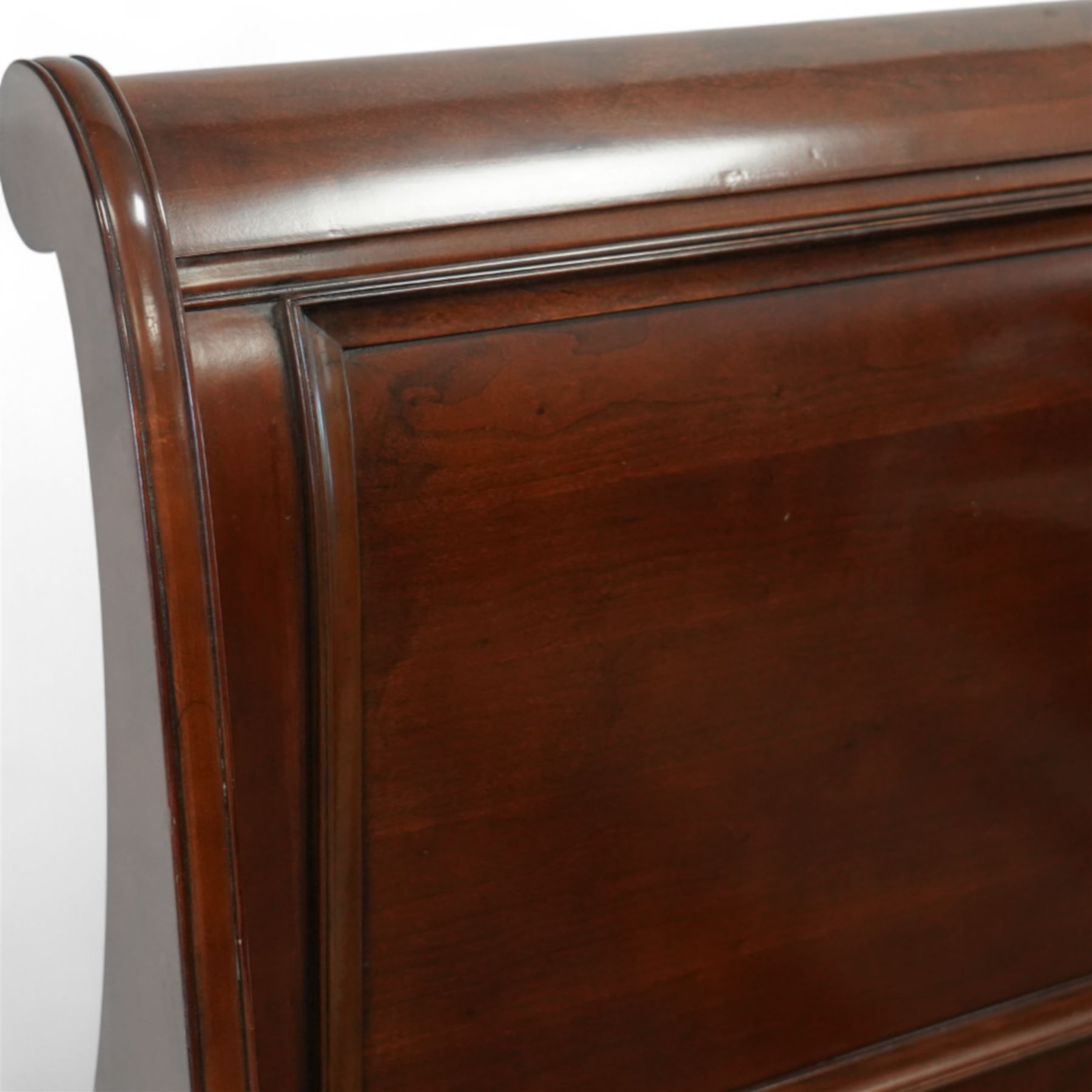 Late 20th-century mahogany Empire-style double sleigh bed, scrolled panelled headboard, and footboard, base with moulded plinth raised on bracket feet